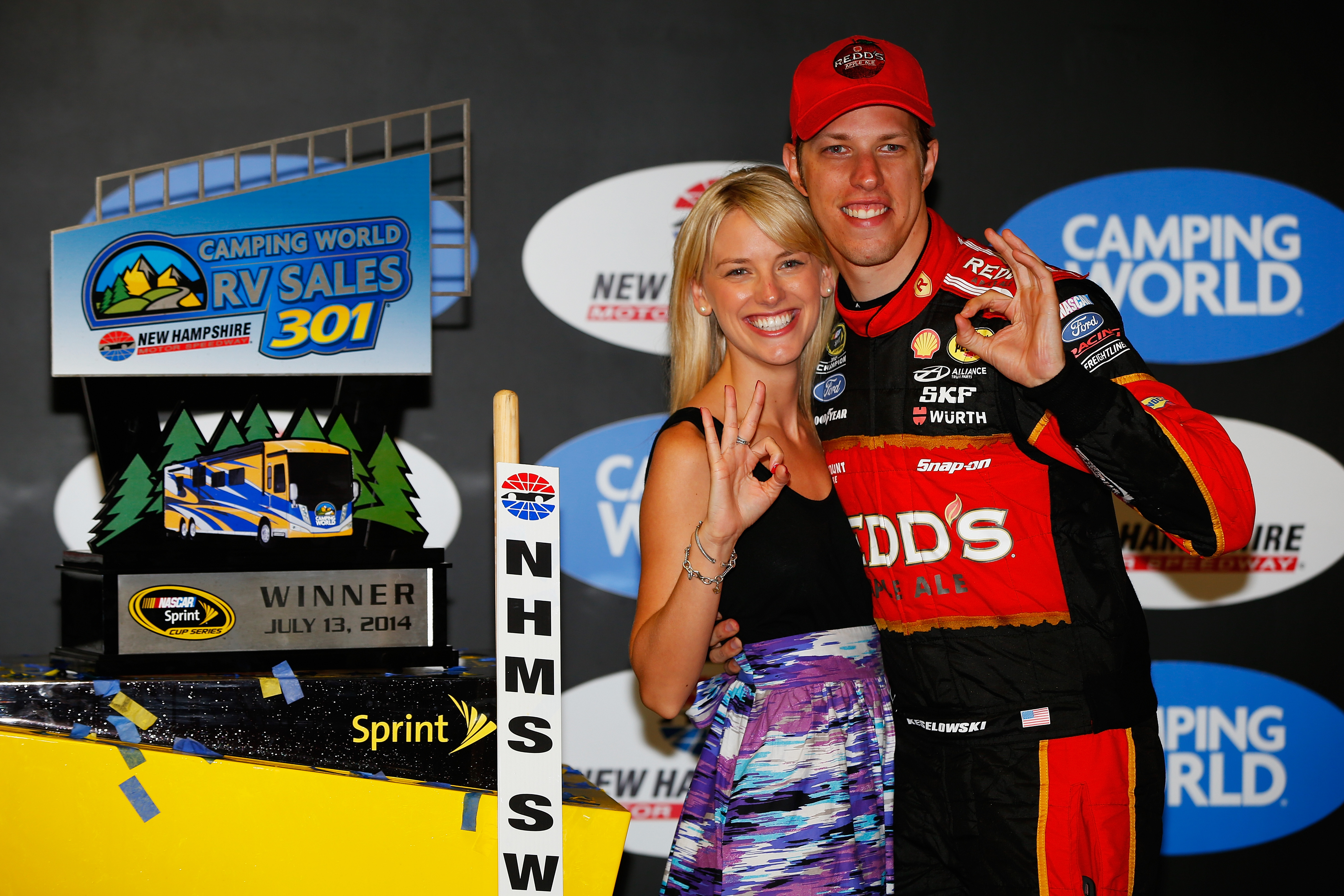 LOUDON, NH - JULY 13:  Brad Keselowski, driver of the #2 Redds Ford, poses with girlfriend Paige White and the Winner's Trophy after winning the NASCAR Sprint Cup Series Camping World RV Sales 301 at New Hampshire Motor Speedway on July 13, 2014 in Loudon, New Hampshire.  (Photo by Matt Sullivan/NASCAR via Getty Images)