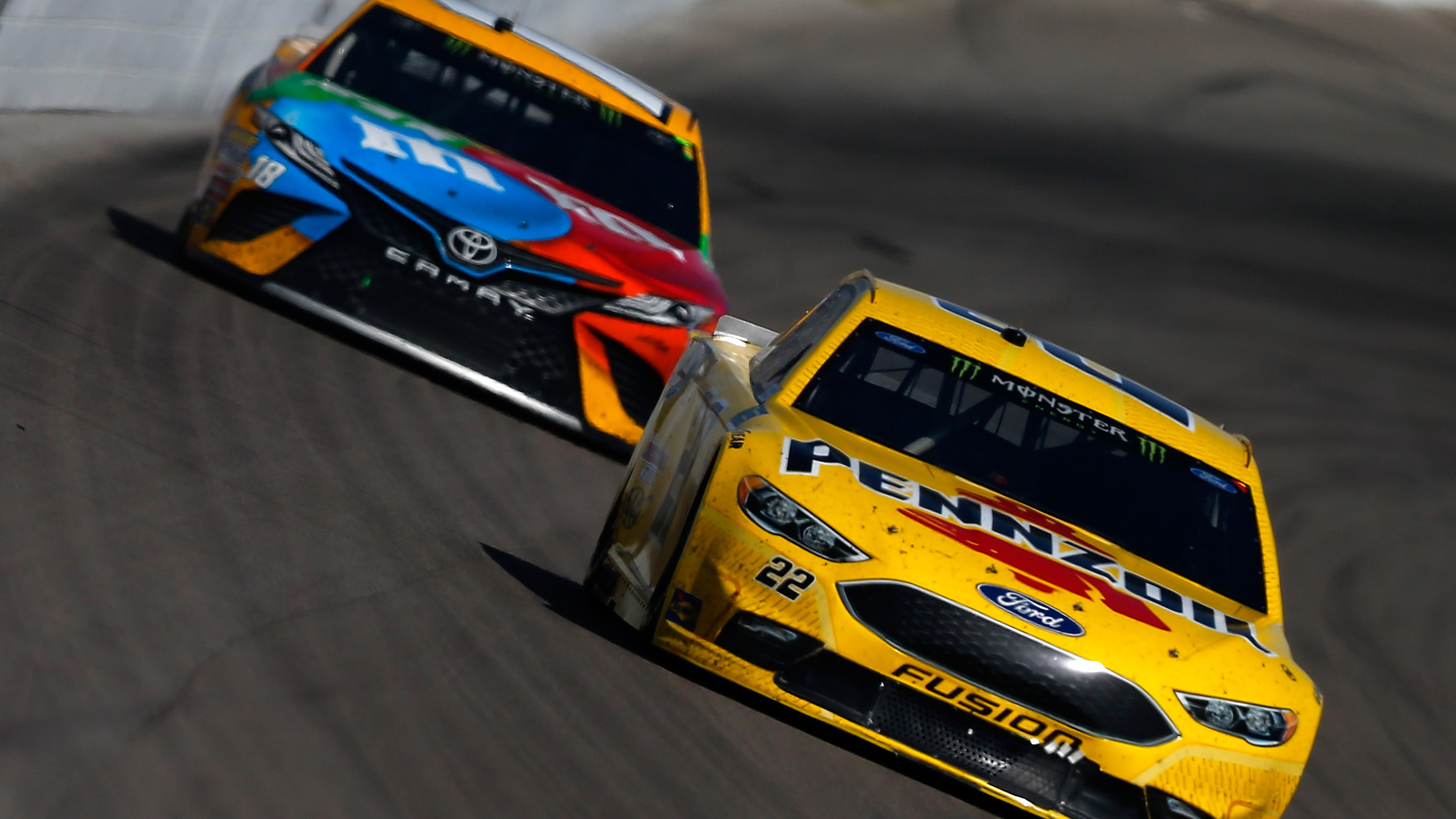 LAS VEGAS, NV - MARCH 12:  Joey Logano, driver of the #22 Pennzoil Ford, leads Kyle Busch, driver of the #18 M&M's Toyota, during the Monster Energy NASCAR Cup Series Kobalt 400 at Las Vegas Motor Speedway on March 12, 2017 in Las Vegas, Nevada.  (Photo by Sean Gardner/Getty Images)
