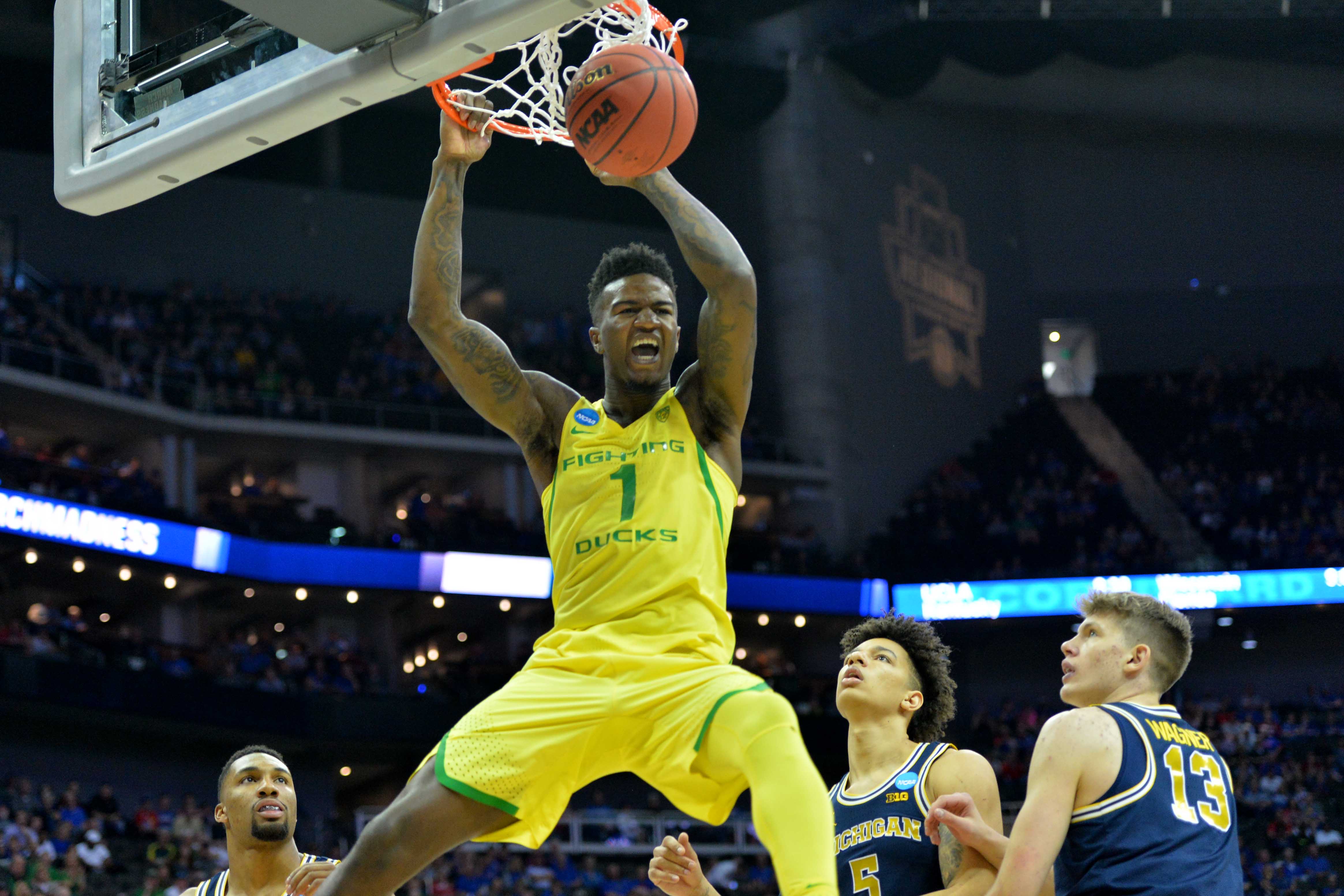 Mar 23, 2017; Kansas City, MO, USA; Oregon Ducks forward Jordan Bell (1) dunks ahead of Michigan Wolverines forward D.J. Wilson (5) and forward Moritz Wagner (13) during the first half in the semifinals of the midwest Regional of the 2017 NCAA Tournament at Sprint Center. Mandatory Credit: Denny Medley-USA TODAY Sports