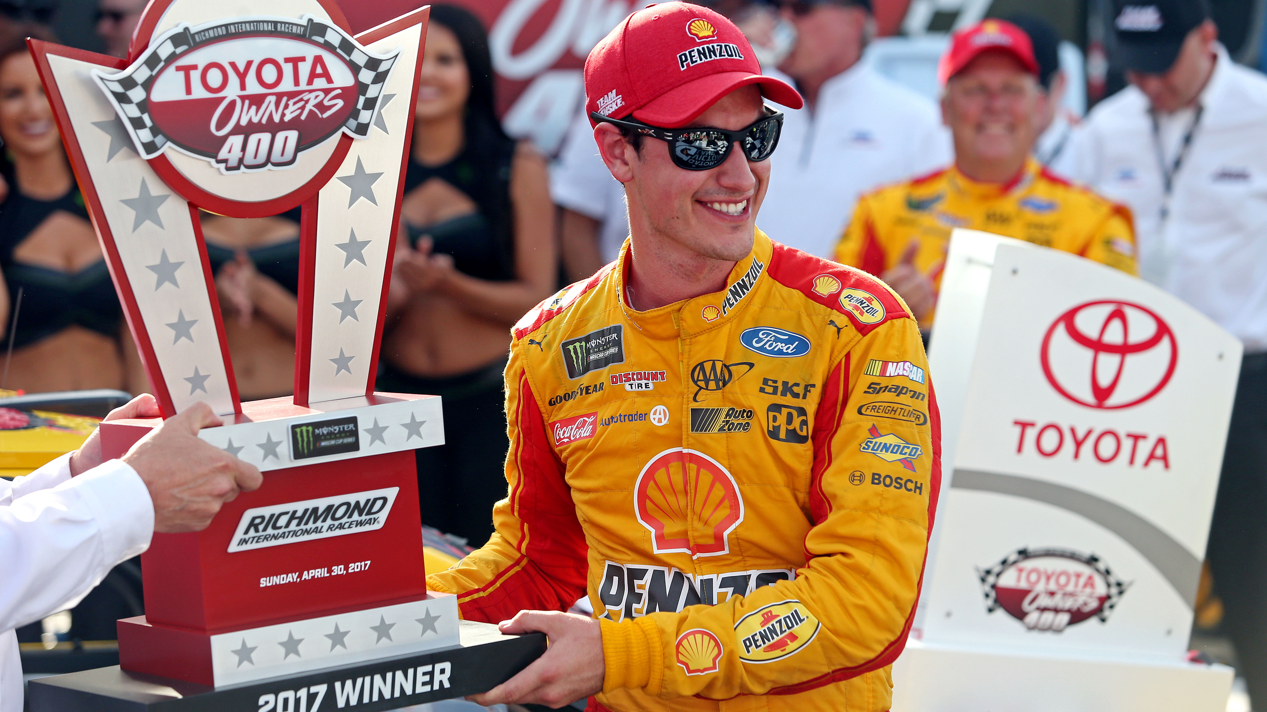 Apr 30, 2017; Richmond, VA, USA; NASCAR Cup Series driver Joey Logano (22) is presenting with the trophy after winning the Toyota Owners 400 at Richmond International Raceway. Mandatory Credit: Peter Casey-USA TODAY Sports