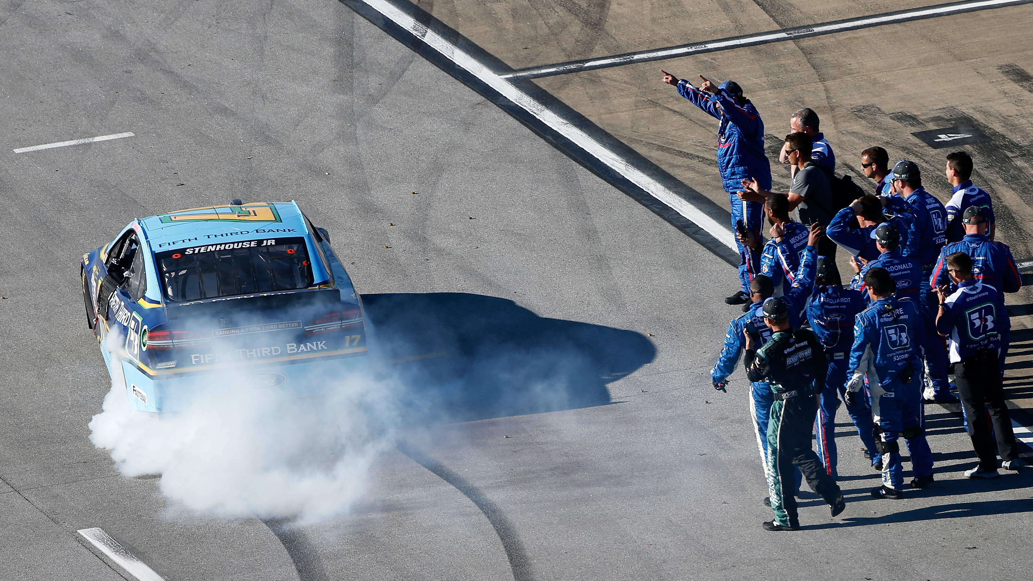 TALLADEGA, AL - MAY 07: Ricky Stenhouse Jr., driver of the #17 Fifth Third Bank Ford, celebrates with a burnout with his crew after winning the Monster Energy NASCAR Cup Series GEICO 500 at Talladega Superspeedway on May 7, 2017 in Talladega, Alabama. (Photo by Brian Lawdermilk/Getty Images)