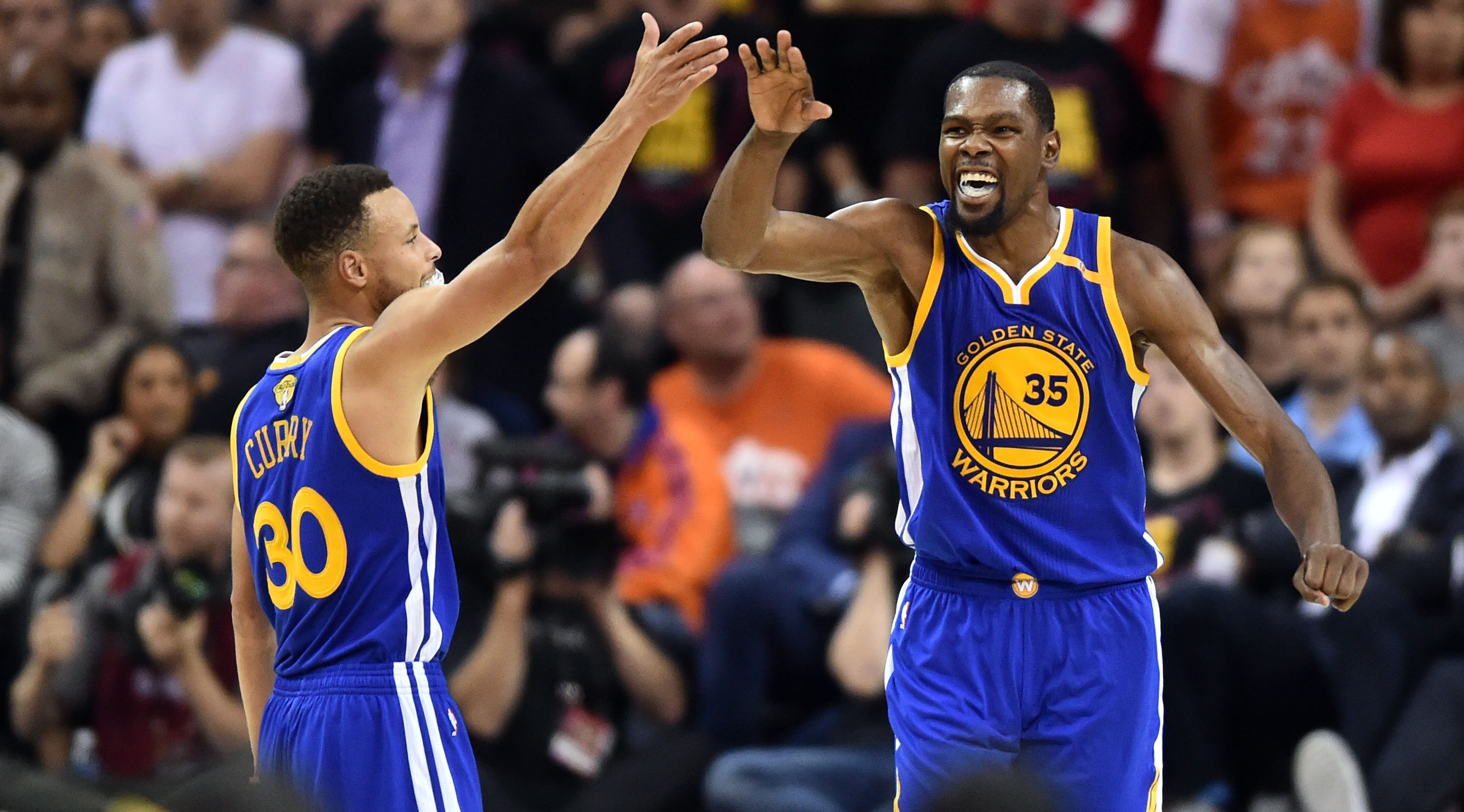 Jun 7, 2017; Cleveland, OH, USA; Golden State Warriors guard Stephen Curry (30) and forward Kevin Durant (35) celebrate during the fourth quarter against the Cleveland Cavaliers in game three of the 2017 NBA Finals at Quicken Loans Arena. Mandatory Credit: Ken Blaze-USA TODAY Sports