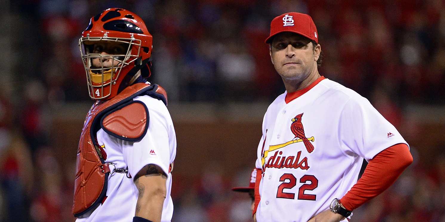 Apr 18, 2017; St. Louis, MO, USA; St. Louis Cardinals catcher Yadier Molina (4) and manager Mike Matheny (22) look on after removing starting pitcher Mike Leake (not pictured) from the game during the seventh inning against the Pittsburgh Pirates at Busch Stadium. The Cardinals won 2-1. Mandatory Credit: Jeff Curry-USA TODAY Sports