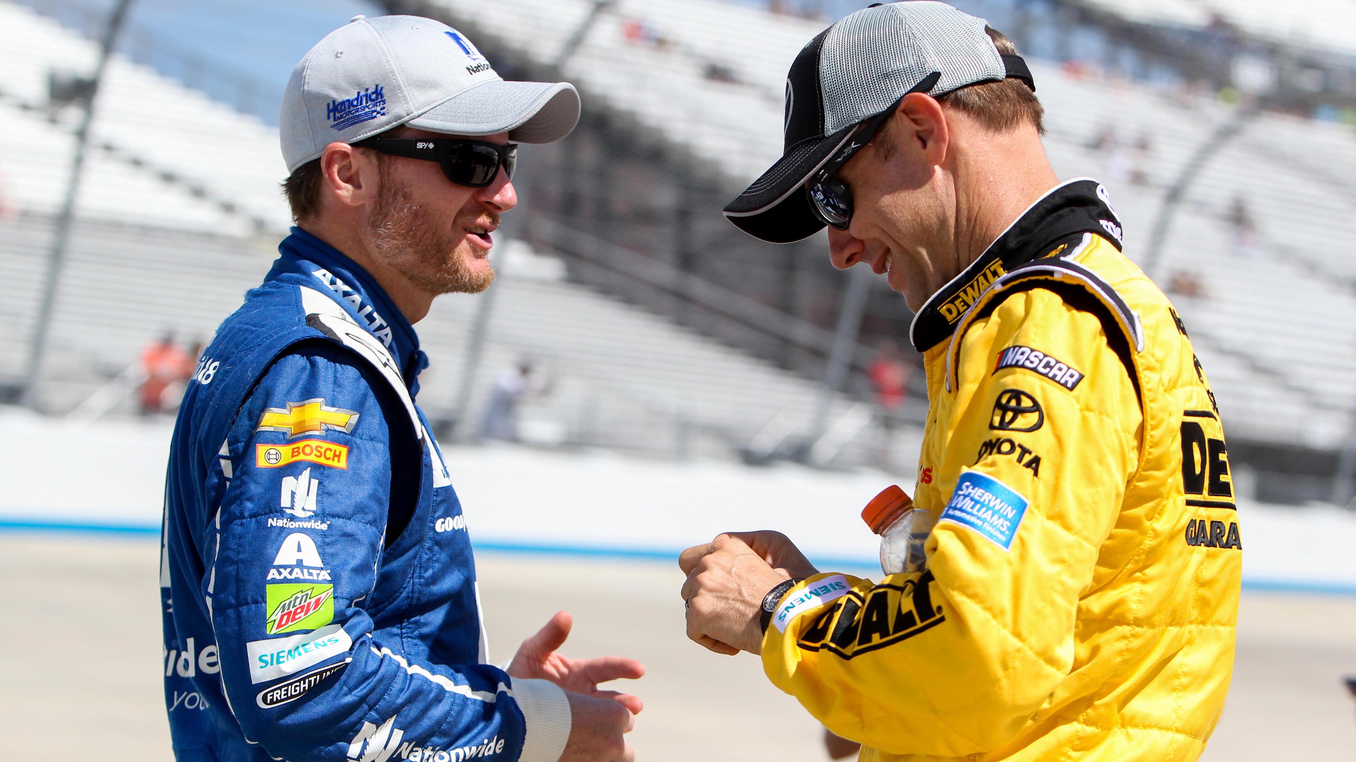 Jun 2, 2017; Dover, DE, USA; NASCAR Cup Series driver Dale Earnhardt Jr (left) and driver Matt Kenseth (right) talk on pit road during the qualifying for the AAA 400 Drive For Autism at Dover International Speedway. Mandatory Credit: Matthew O'Haren-USA TODAY Sports