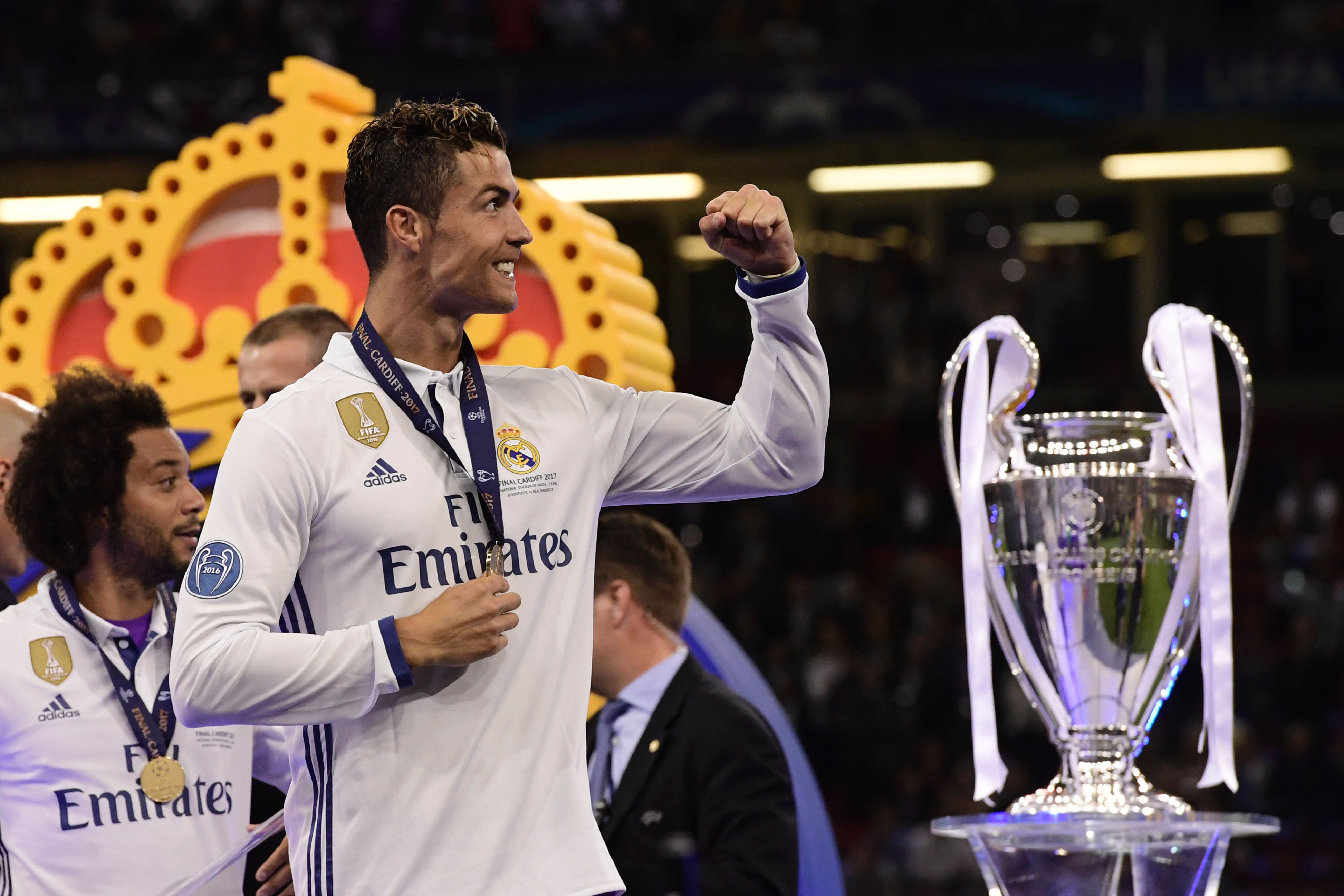 Real Madrid's Portuguese striker Cristiano Ronaldo celebrates next to the trophy after Real Madrid won the UEFA Champions League final football match between Juventus and Real Madrid at The Principality Stadium in Cardiff, south Wales, on June 3, 2017. / AFP PHOTO / JAVIER SORIANO        (Photo credit should read JAVIER SORIANO/AFP/Getty Images)