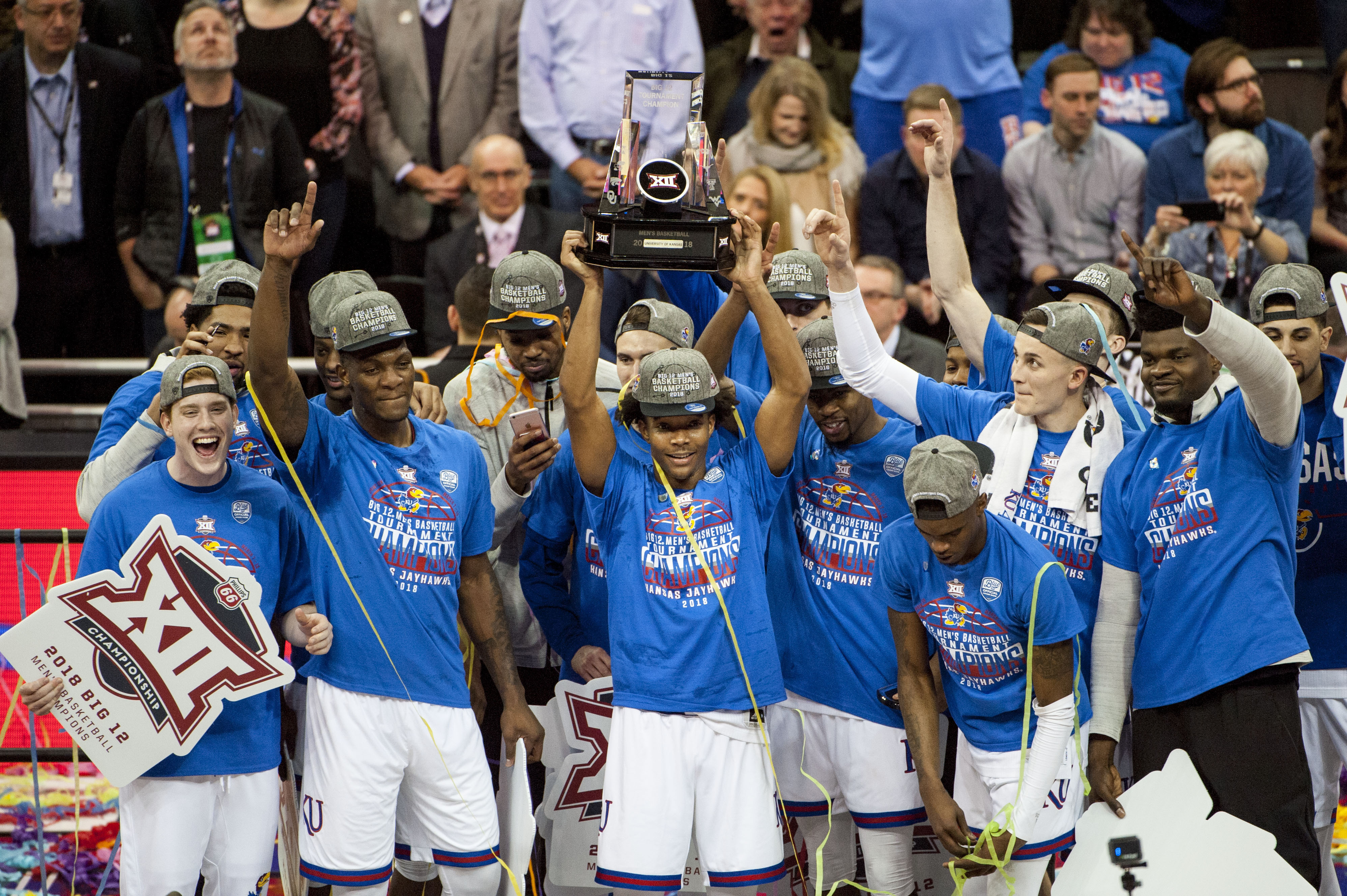 Mar 10, 2018; Kansas City, MO, United States; Kansas Jayhawks guard Devonte' Graham (4) holds up the Big 12 championship trophy after defeating the West Virginia Mountaineers in the Big 12 Tournament final at Sprint Center. Mandatory Credit: Amy Kontras-USA TODAY Sports